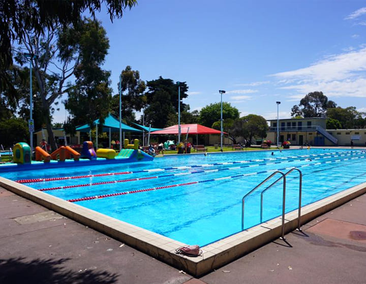 swimming pool with pool furniture. swimming pool racing lane and a mounted swimming pool ladder